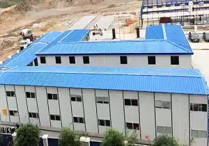 A prefabricated school building with a blue roof in Dhaka.